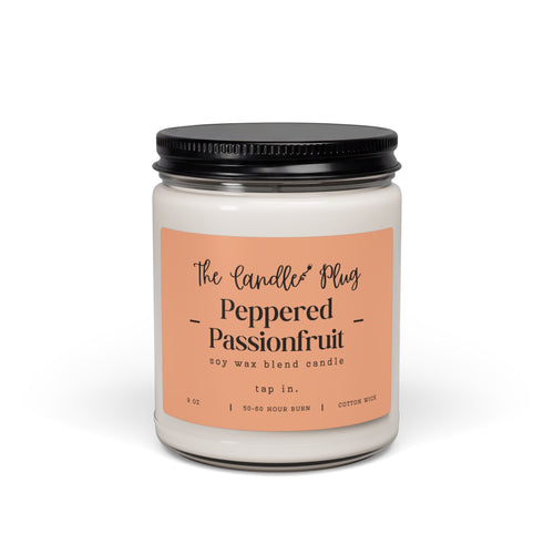 A 9 oz Peppered Passionfruit soy candle in a clear glass jar with a black metal lid and a peach-colored label. The label reads 'The Candle Plug' and 'Peppered Passionfruit'.