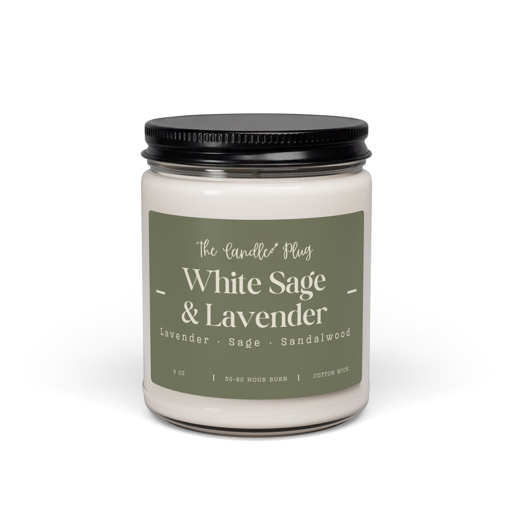 A jar candle with white wax, a black metal lid, and a muted sage green label reading 'White Sage & Lavender' by The Candle Plug, shown on a clean white background.